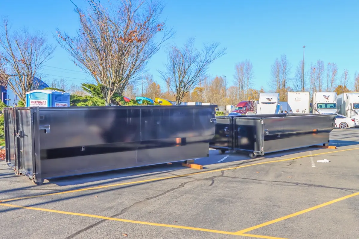 Professional dumpster rental service with roll-off container on residential driveway in Youngtown